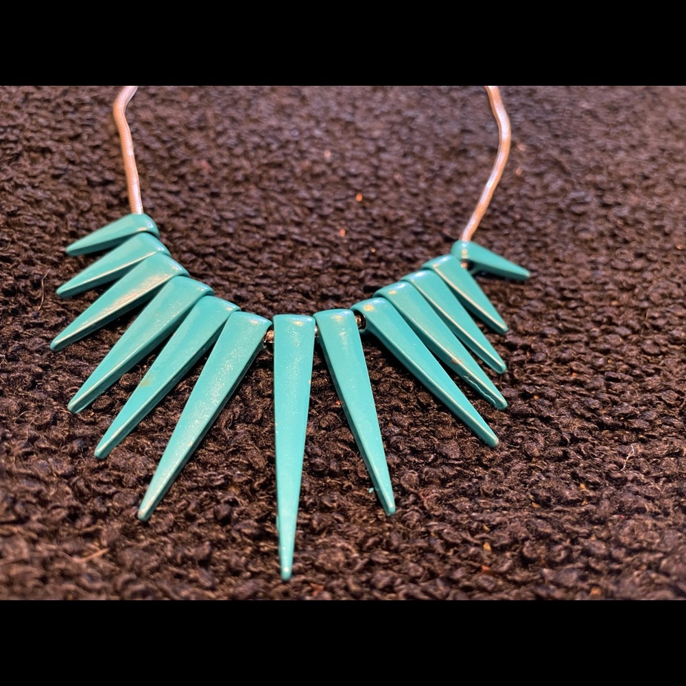 Silver toned necklace with blue spikes